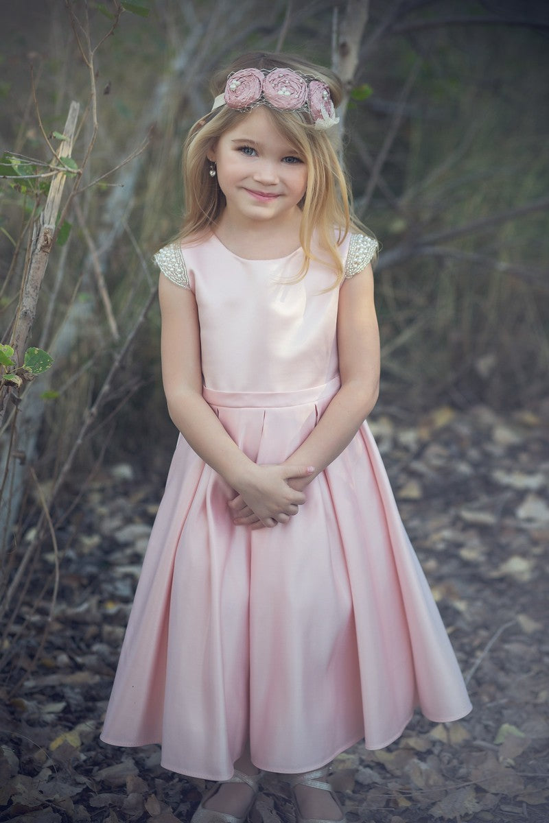 Beaded cap sleeve girls party dress pink front view.
