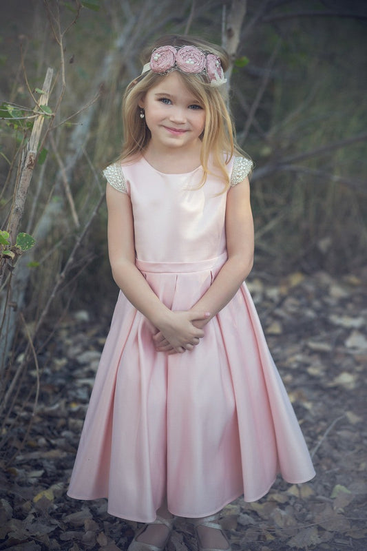 Beaded cap sleeve girls party dress pink front view.