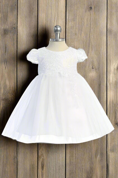 White scalloped lace sleeve baby girls dress with sequins on the bodice, displayed on a mannequin.